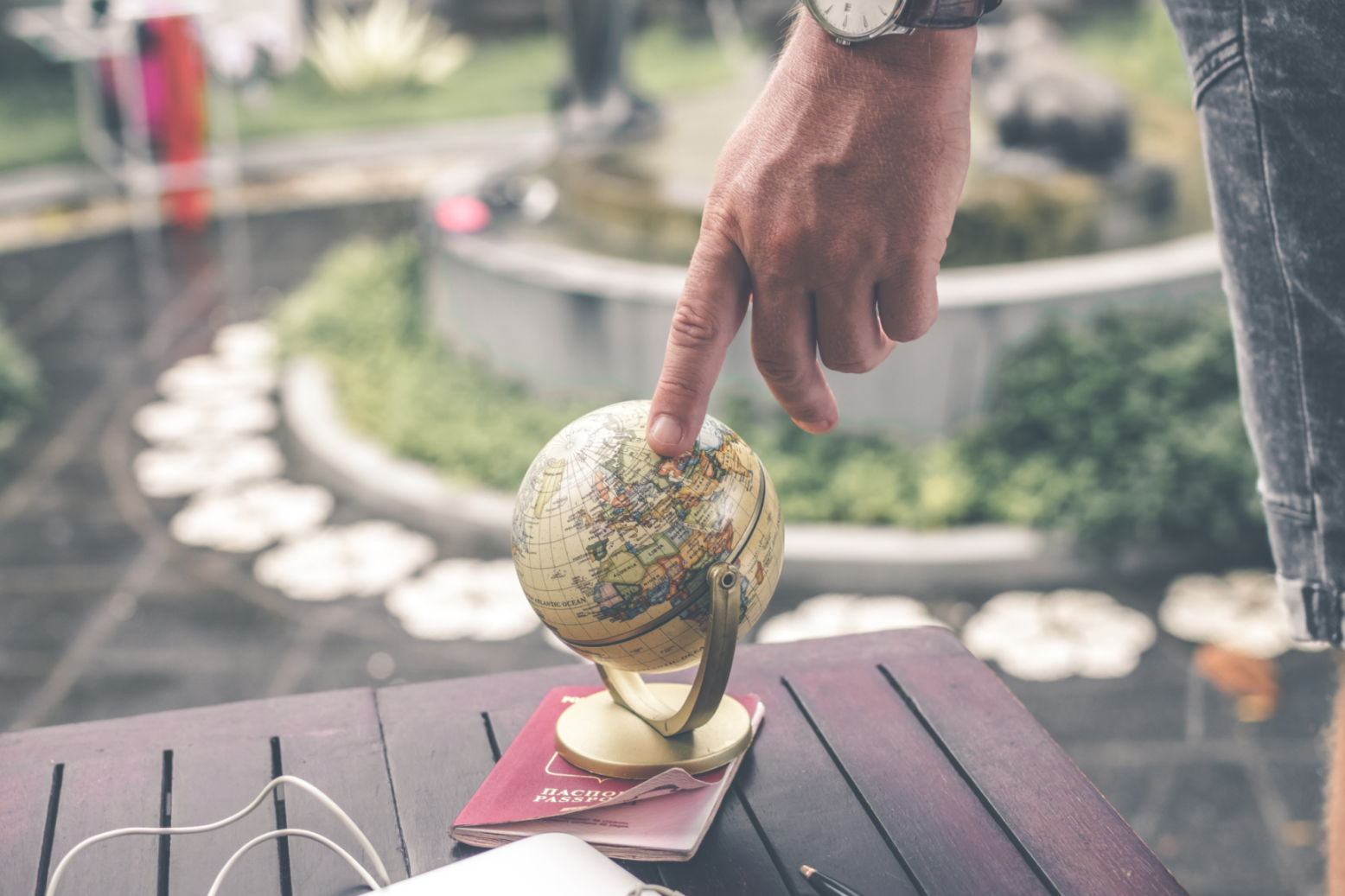 Person Pointing At Globe